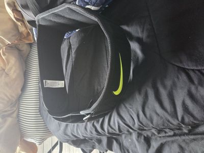 Black Nike weightlifting belt has lime green swoos