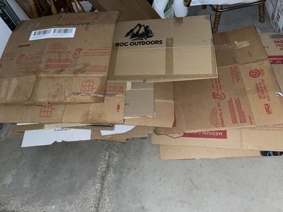 Assorted Used Cardboard Boxes and Flattened Cartons for Moving and Storage