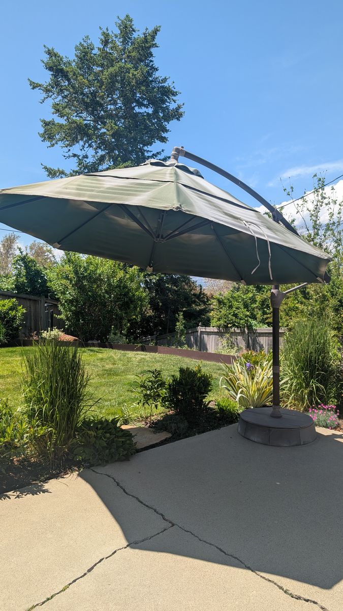 Large cantilever patio umbrella with sand weighted base - $25