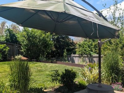 Large cantilever patio umbrella with sand weighted base - $25