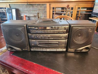Sharp boom box with AM/FM, CD, and tape player. Everything works perfect. Has Bass boost...SOUNDS FANTASTIC.