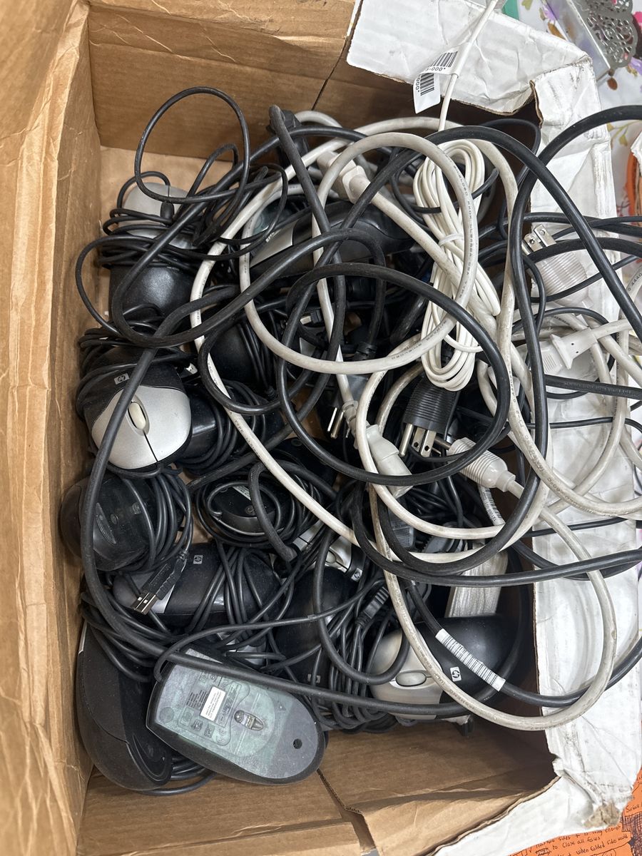 Box of computer mice and power supply cables