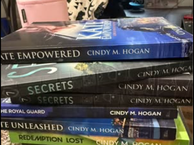 7 Cindy M. Hogan Suspense Books (Like New & Signed to "Ashley")