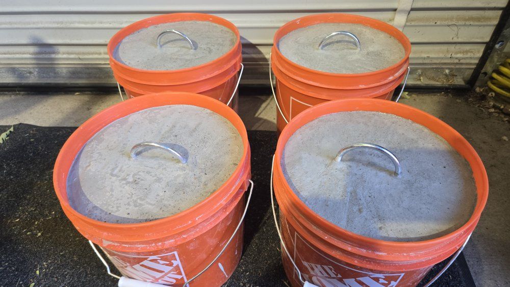 Concrete bucket tent weights