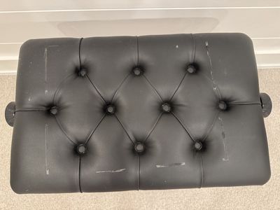 Black piano bench