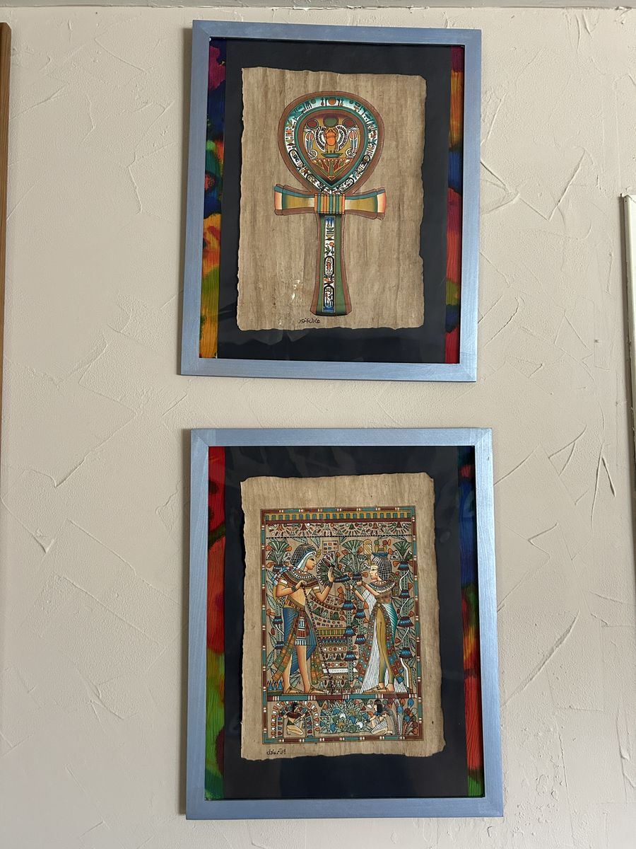 Set 2 framed Egyptian papyrus artworks featuring traditional ancient Egyptian designs.