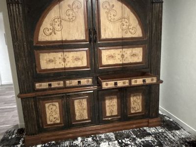 Ornate Dark Wood Armoire with Intricate Carvings and Light Accents - Storage Cabinet