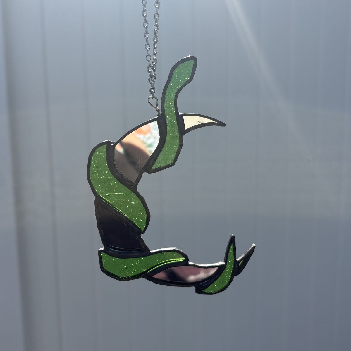 Stained glass snake warppaed around moon