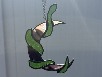 Stained glass snake warppaed around moon