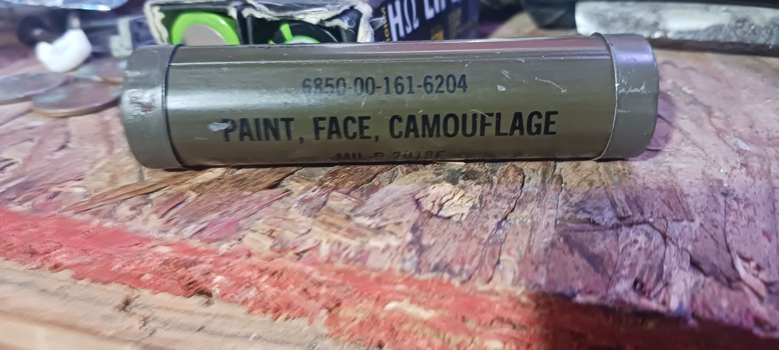 Camouflage face, jacket, notebook