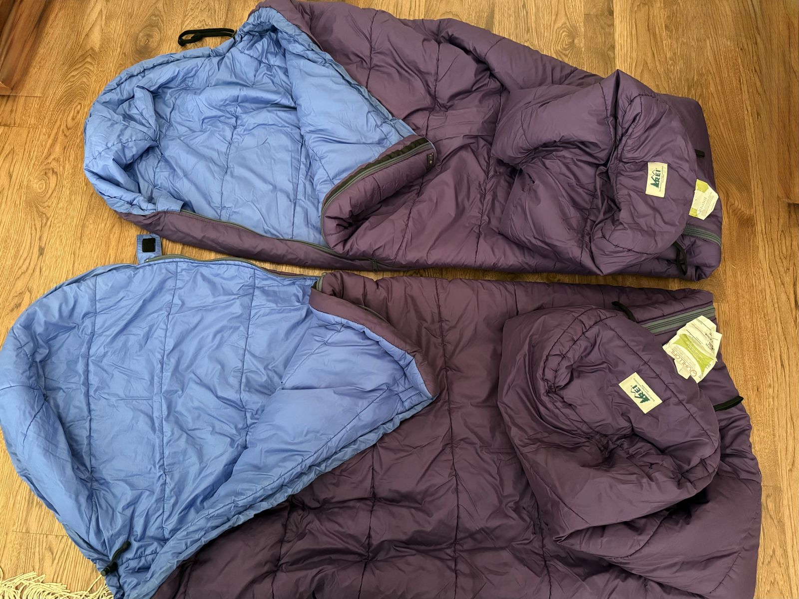Two REI lightweight 3 season synthetic quallofil non allergenic sleeping bags with hood and stuff sacs. Excl condition like new.