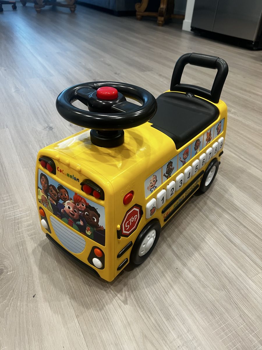 CoComelon Yellow School Bus Ride-On Toy with Steering Wheel and Sound Buttons