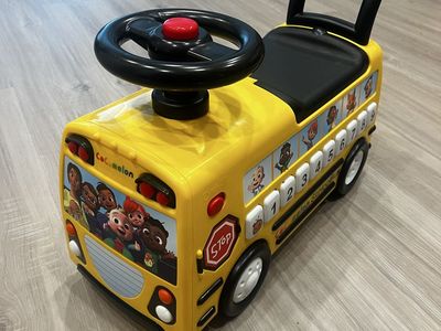 CoComelon Yellow School Bus Ride-On Toy with Steering Wheel and Sound Buttons