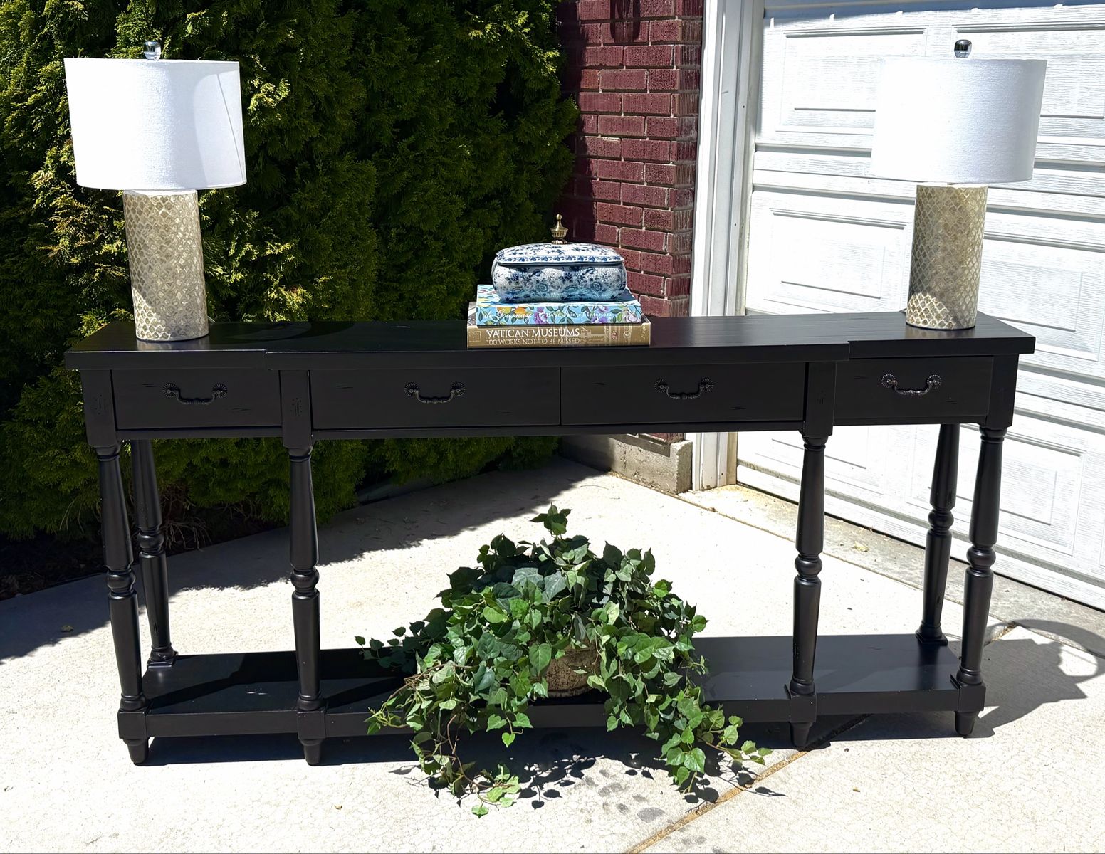 Black Console Table with four Drawers. (Decorations not included)