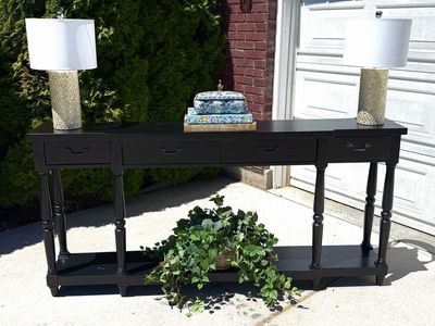 Black Console Table with four Drawers. (Decorations not included)