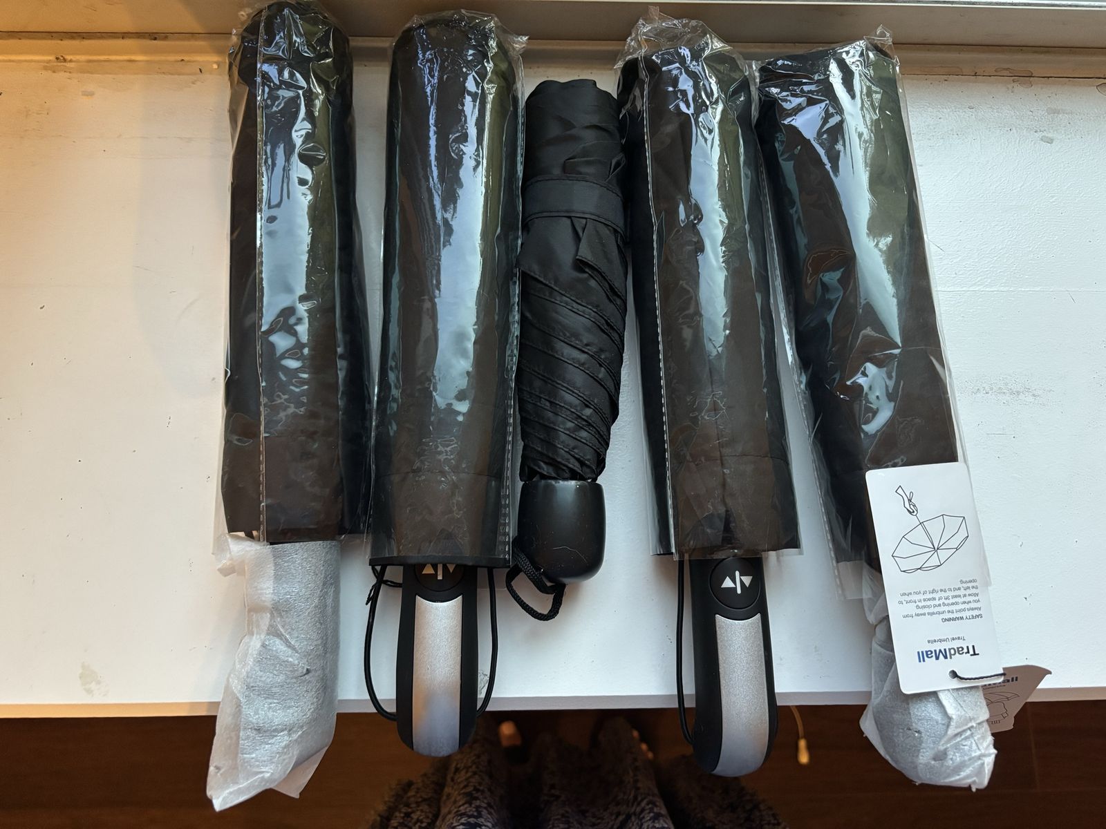 TradMall Travel Umbrellas - 4 Pack Automatic Open/Close Black Compact Umbrellas. Also one used umbrella