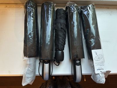 TradMall Travel Umbrellas - 4 Pack Automatic Open/Close Black Compact Umbrellas. Also one used umbrella