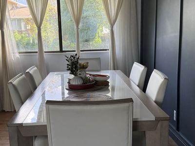 Modern Wooden Dining Table with White Upholstered Chairs