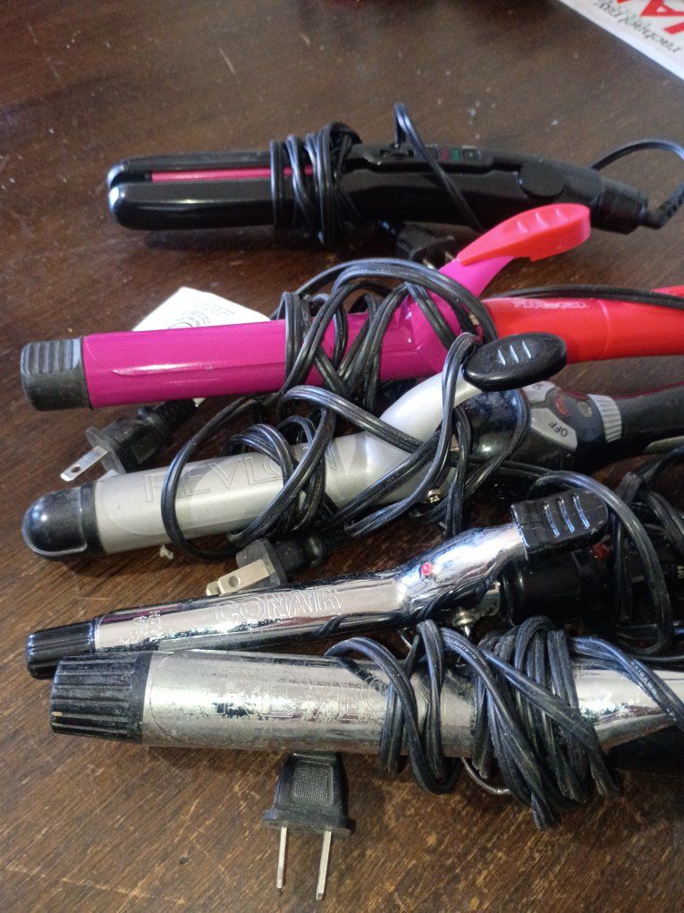 4 curling irons and a straightener
