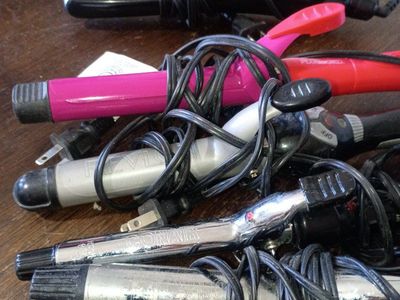 4 curling irons and a straightener