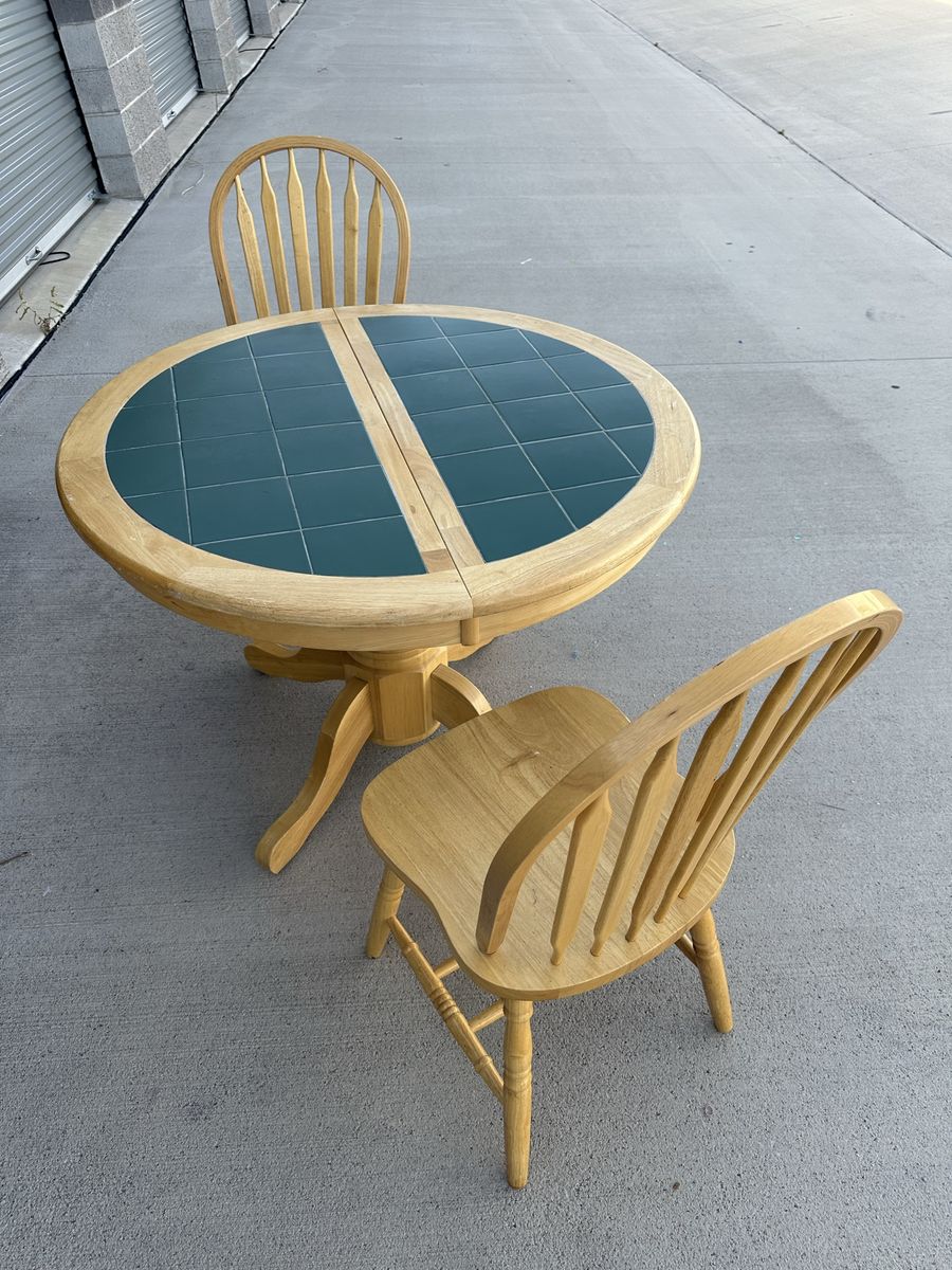 Wood and Tile expandable pedestal dining table and two oak chairs