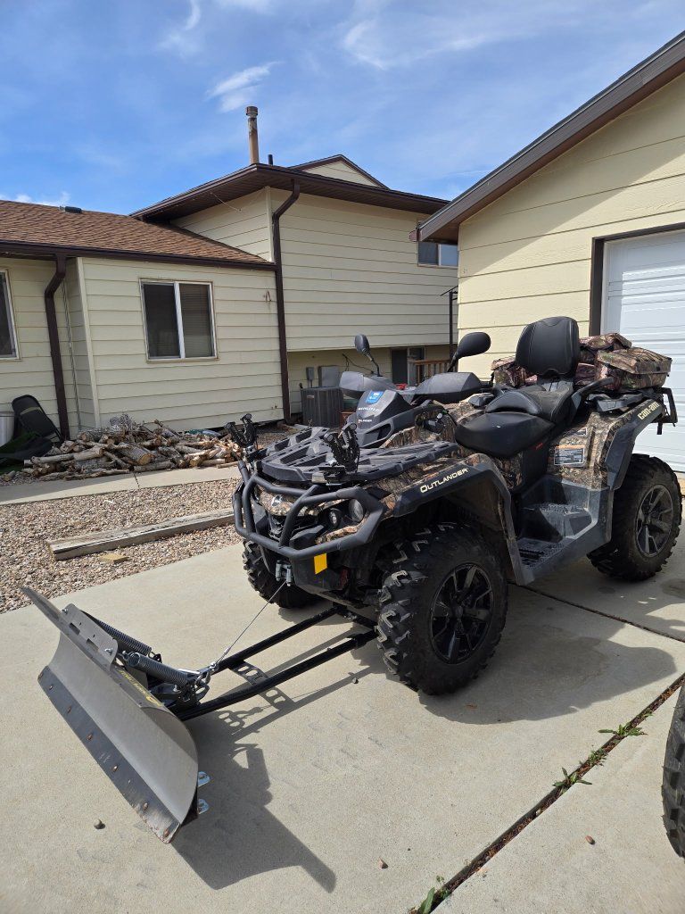 Can-Am Outlander ATV with Snow Plow and Camo Storage Bags