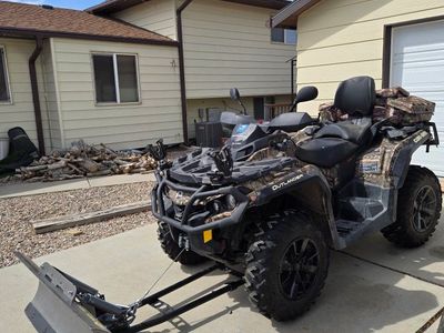 Can-Am Outlander ATV with Snow Plow and Camo Storage Bags