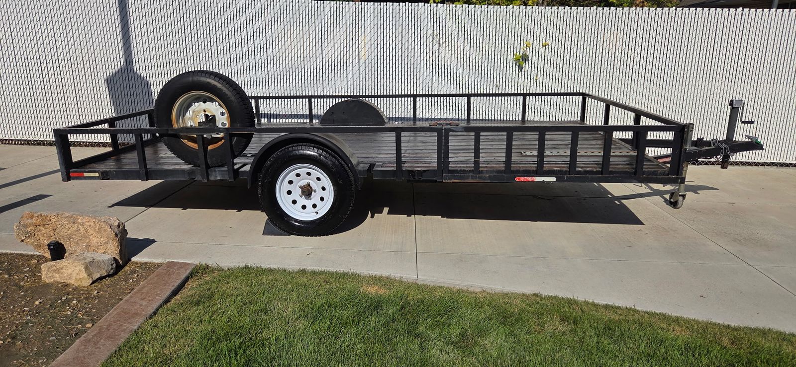 2014 8' x 14' Flatbed Utility Trailer. Loads from side or rear & includes a title.