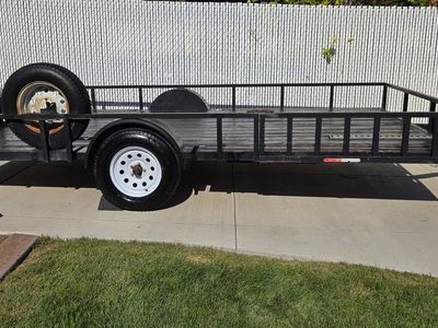 2014 8' x 14' Flatbed Utility Trailer. Loads from side or rear & includes a title.