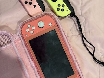 Nintendo Switch Lite with charger & extra controllers