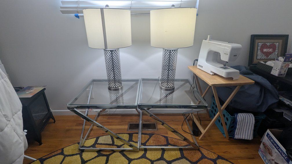 Set of two glass tables with two metal lamps