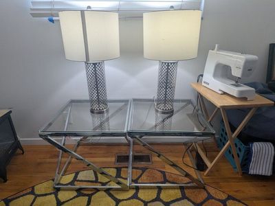 Set of two glass tables with two metal lamps