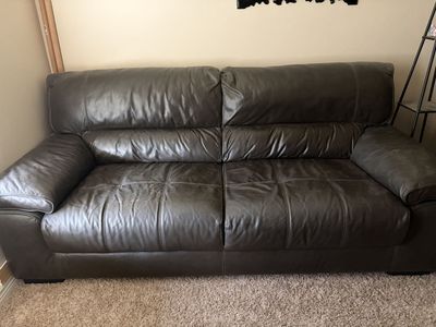 Dark Gray Vinyl Couch Sofa with Visible Wear and Scratch Damage