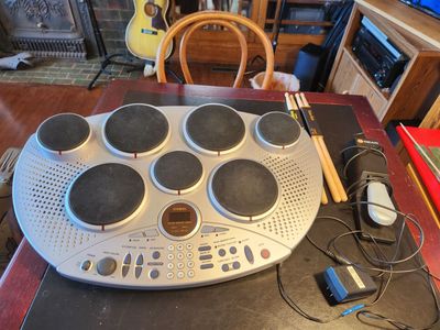 Casio electronic drum kit with foot pedal and four drumsticks. MIDI ports. Model MD-80-. Works great. Very fun.
