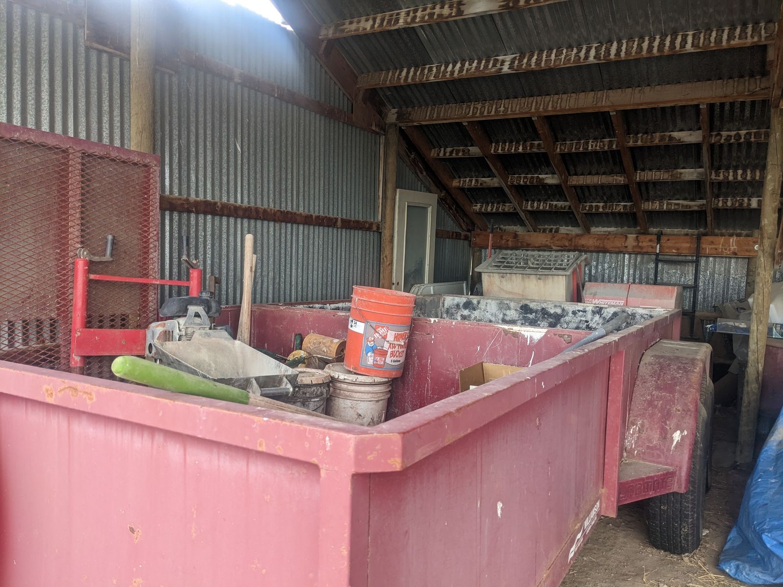 Curbing trailer including mixer, curbing machine and trencher.