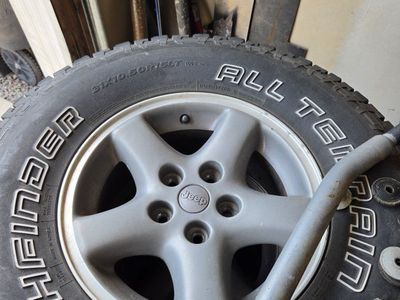 Set of 4 Pathfinder All Terrain Tires 31x10.50R15LT on Jeep 5-Spoke Alloy Wheels