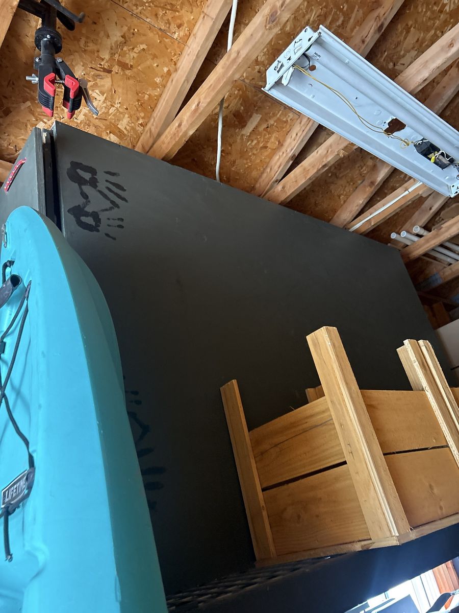 Wood bed frame build for sleeping on. Has a drawer for storage that can be pulled out for a grill to cook on. Cost me $350