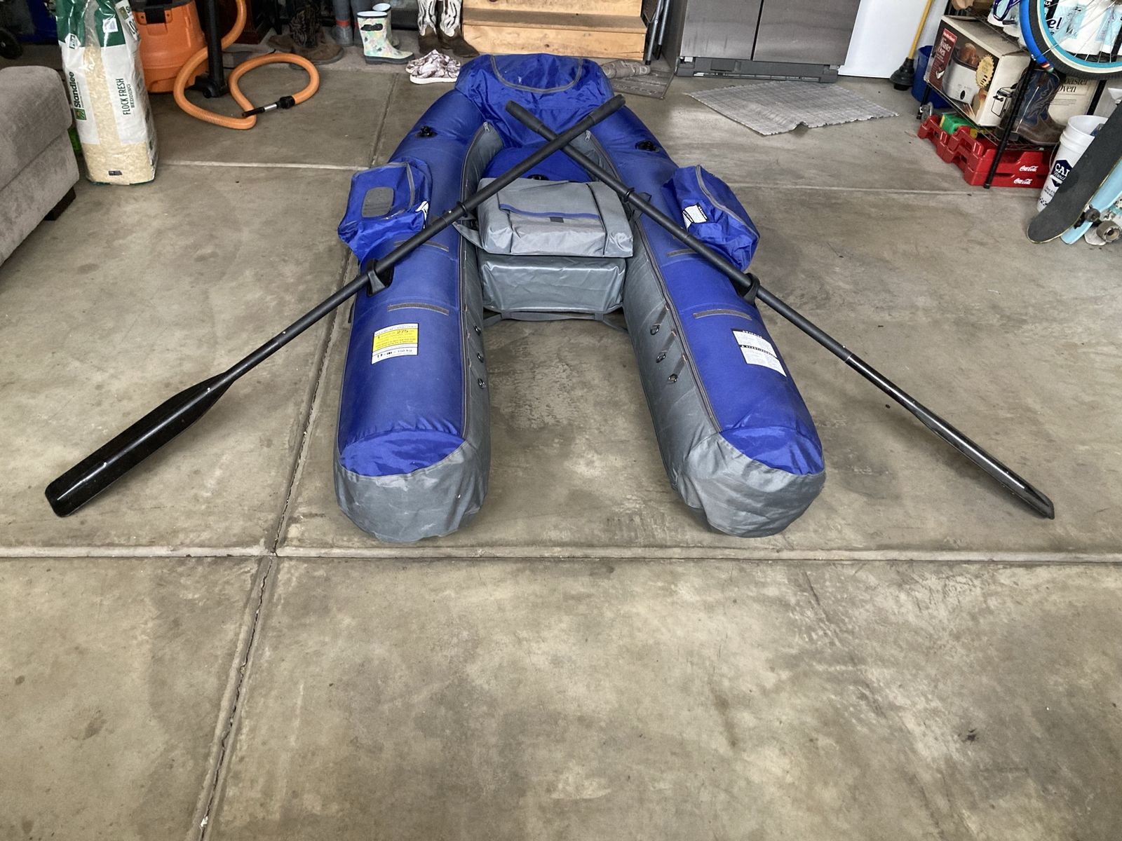 Classic Inflatable Fishing Float Tube with Oars and flippers.