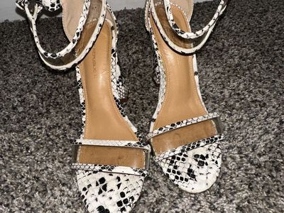 White high heels with snake print
