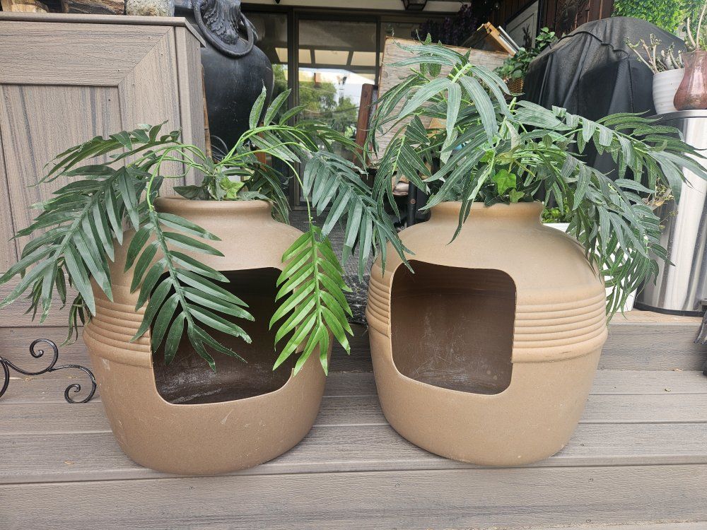 two matching fake plant litter boxes