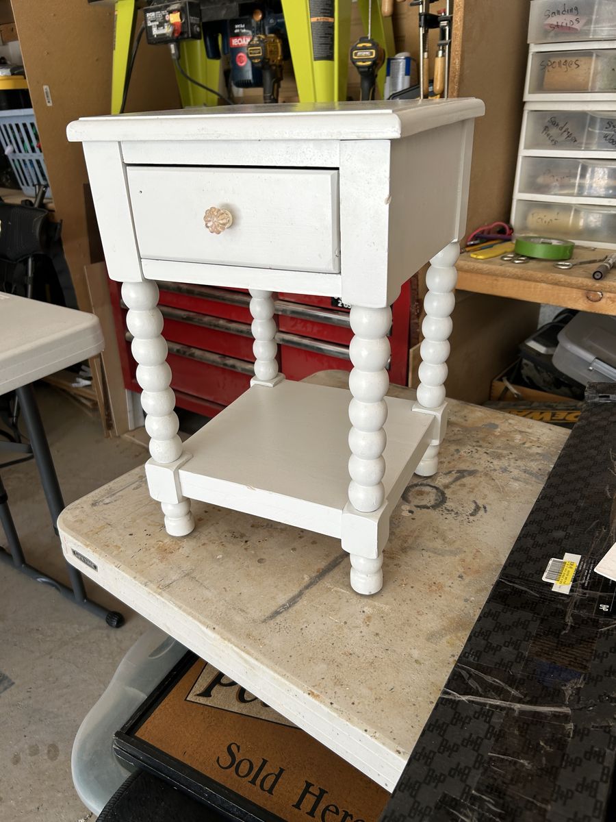 White Painted Wooden Nightstand with Spindle Legs and Lower Shelf