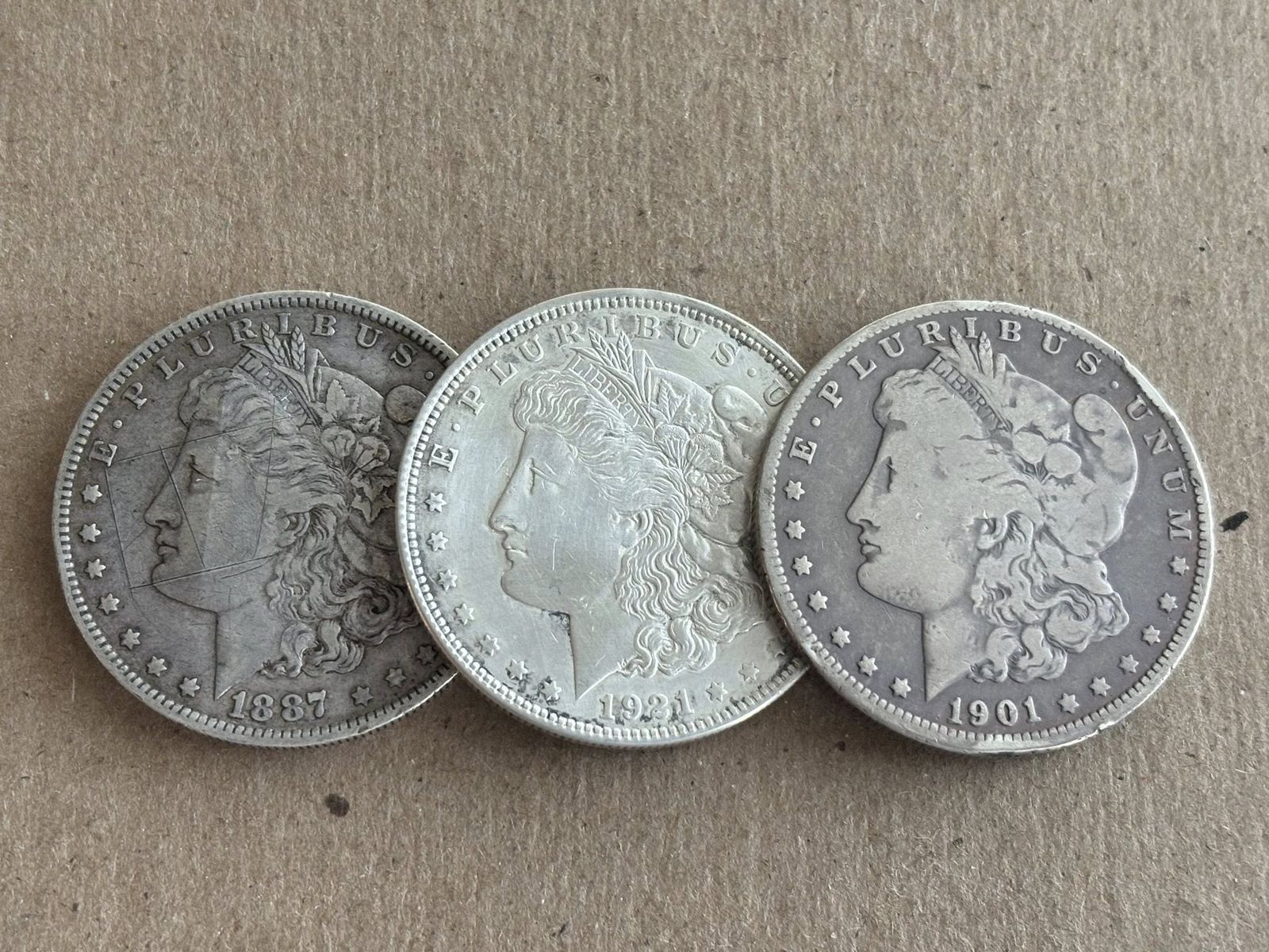 3 Morgans 1887o, 1990o off center strike, 1921p
