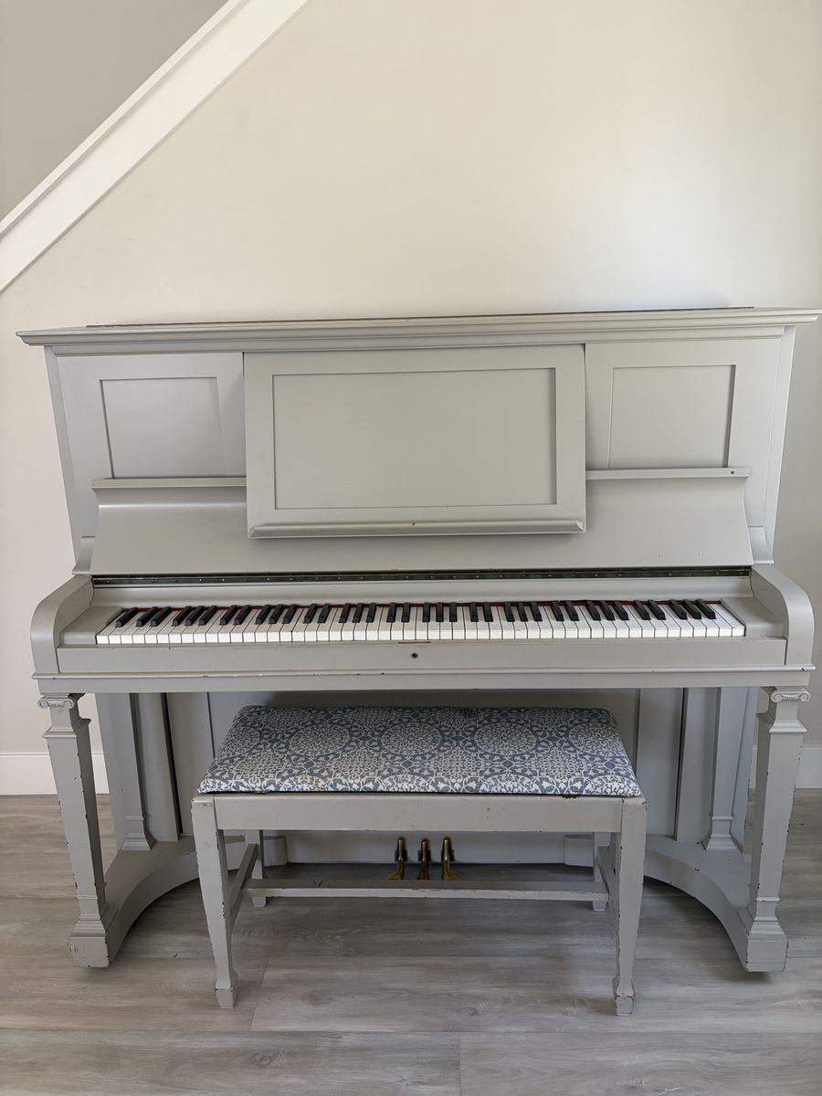Cute upright piano and bench