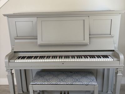 Cute upright piano and bench