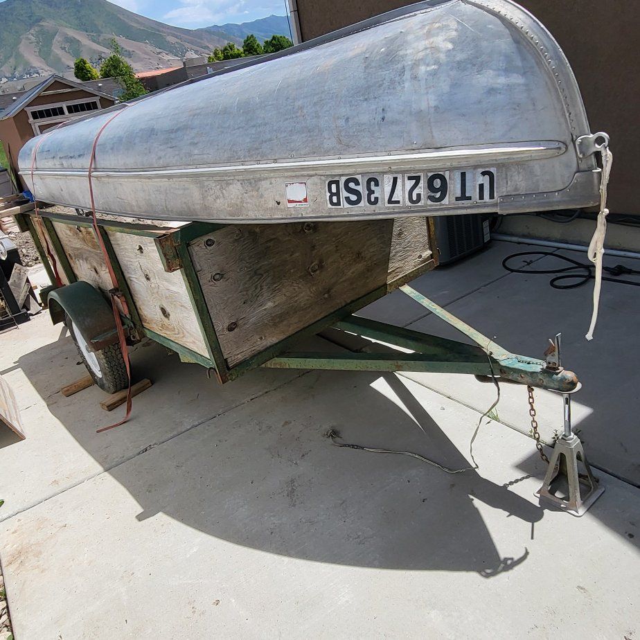 Small fishing boat with utility trailer