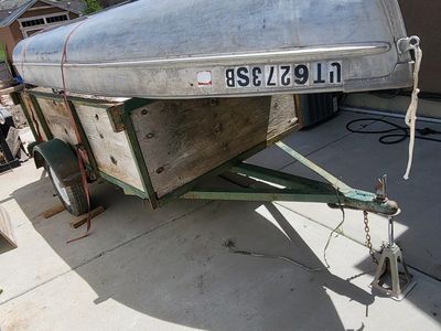 Small fishing boat with utility trailer