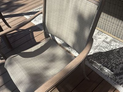 Stackable Sunbrella patio chairs.