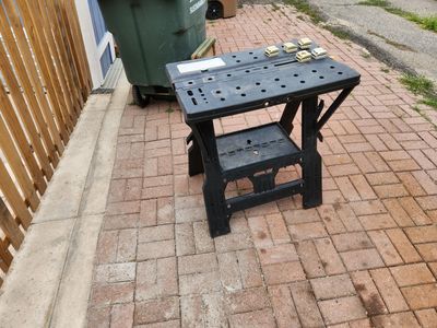 Solid work bench table with a screw clamp and 8 dogs. The whole table can fold up in half. It works well.