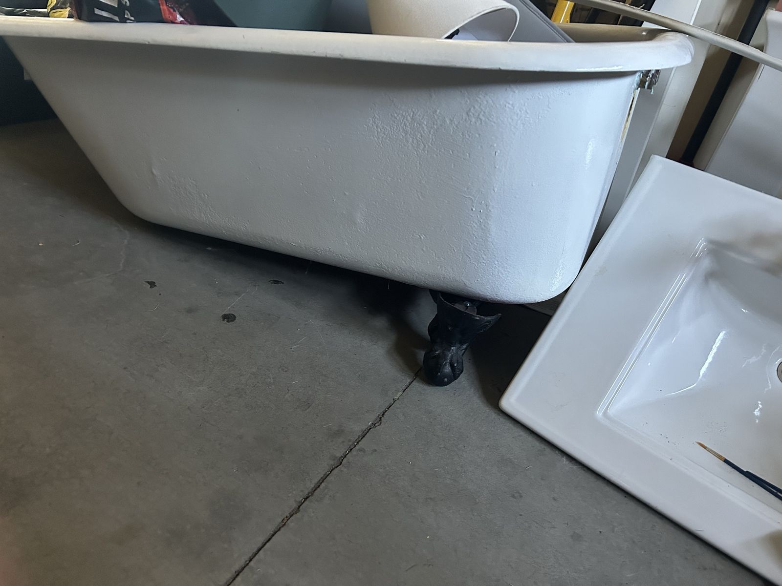 Vintage Cast Iron Clawfoot Bathtub with Decorative Black Feet recently restored.