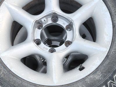 Silver 6-Lug Wheels fit Toyota (Set of 4) with Goodyear Wrangler 31x10.50R15LT Tires.